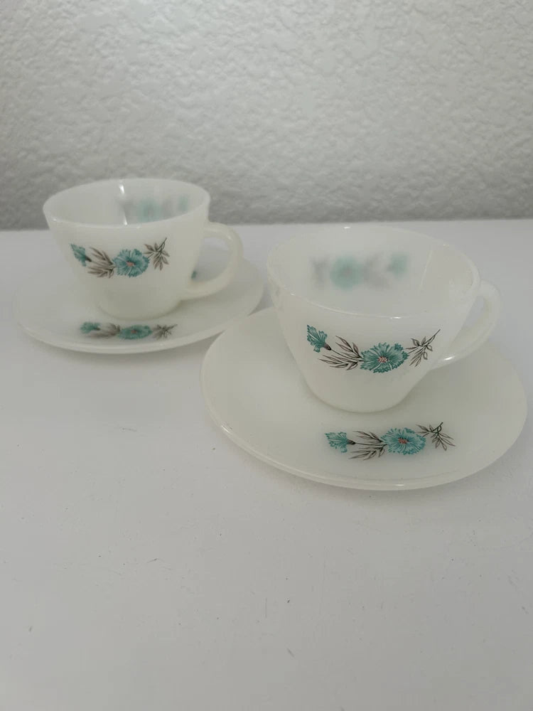 Vintage white teacup and saucer set with teal floral pattern