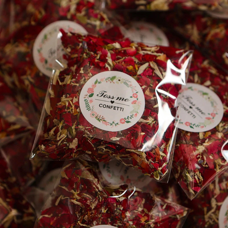 Biodegradable red rose petal confetti in clear pouch with Toss Me Confetti label