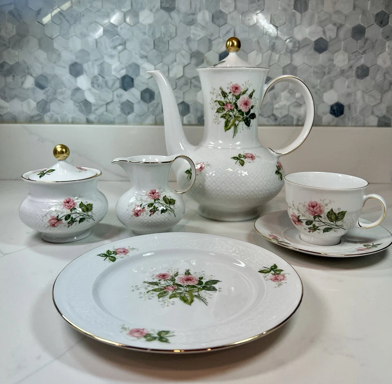 Vintage porcelain tea set with pink rose floral pattern and gold trim