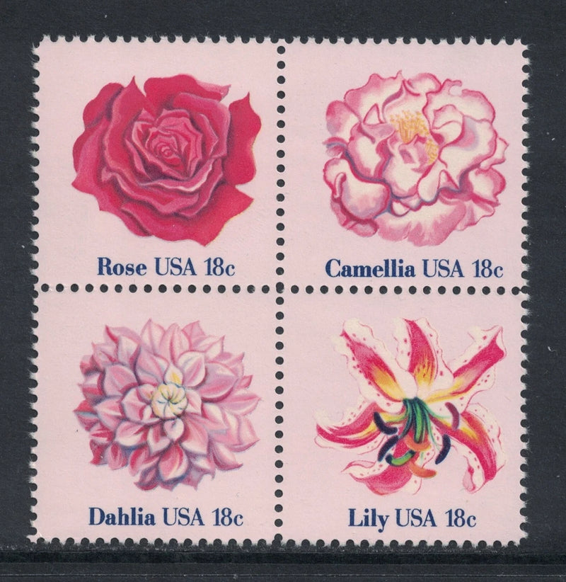 Set of 4 unused postage stamps with rose, camellia, dahlia, and lily flower designs