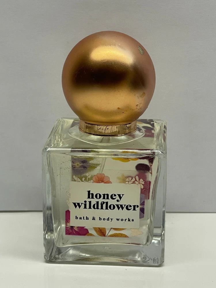 Women’s perfume bottle with honey wildflower label and gold cap, glass spray