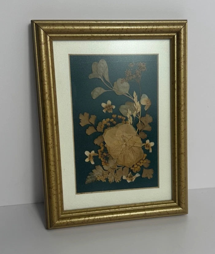 Gold framed shadow box wall art with teal dried botanical flowers
