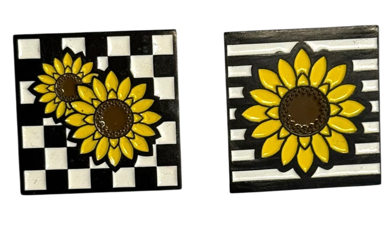 Sunflower lapel pin with two yellow flowers, dark centers, on black-and-white checker background