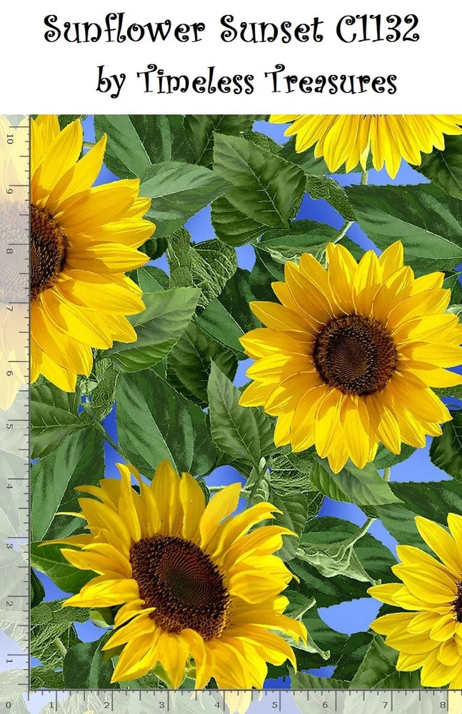 Cotton quilt fabric with large yellow sunflower blooms and green leaves on blue background