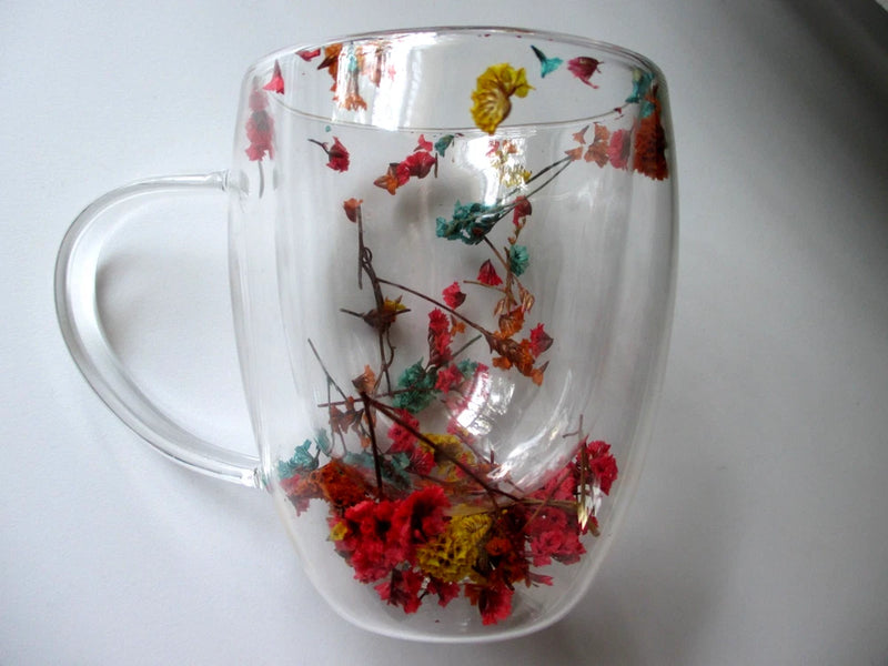 Double wall clear glass mug with colorful botanical dried flowers inside