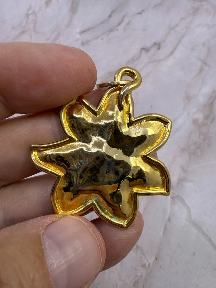 Gold-tone sunflower pendant with loop bail, polished shine