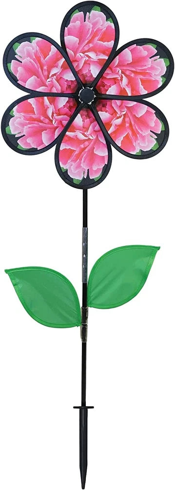 Peony flower wind spinner with pink petals, black blades, and green leaves on a stake
