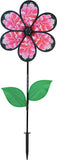 Peony flower wind spinner with pink petals, black blades, and green leaves on a stake
