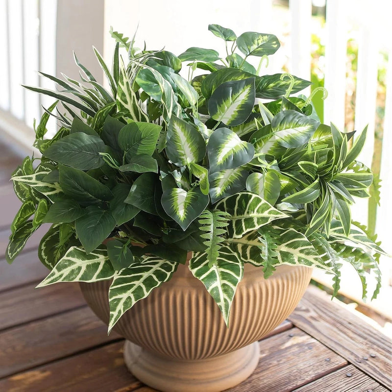 Faux outdoor greenery plant with mixed green leaves in beige ribbed planter pot