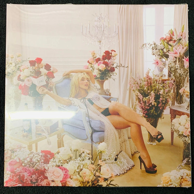 Vinyl LP record sleeve with floral bouquet illustration and woman in dusty rose tones