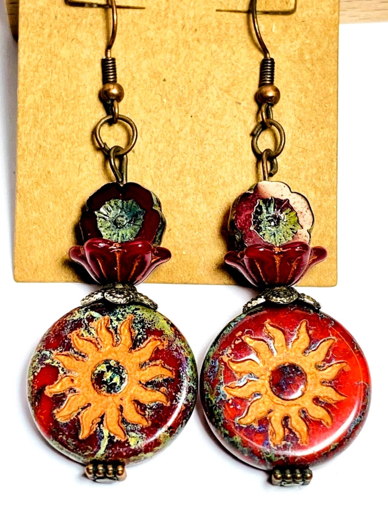Red and orange sunflower drop earrings with circular glass charms and hook backs