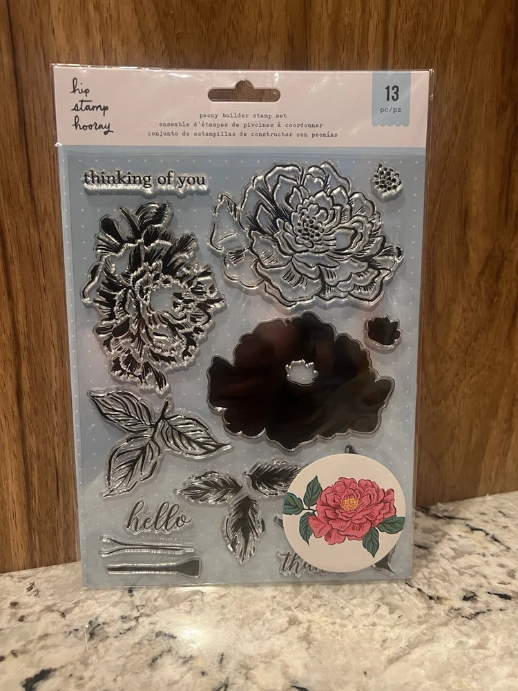 Peony cling acrylic stamp set with layered flowers, leaves, and greeting sentiments
