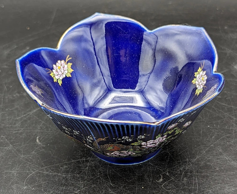 Cobalt blue porcelain lotus-shaped bowl with gold trim and white flower details