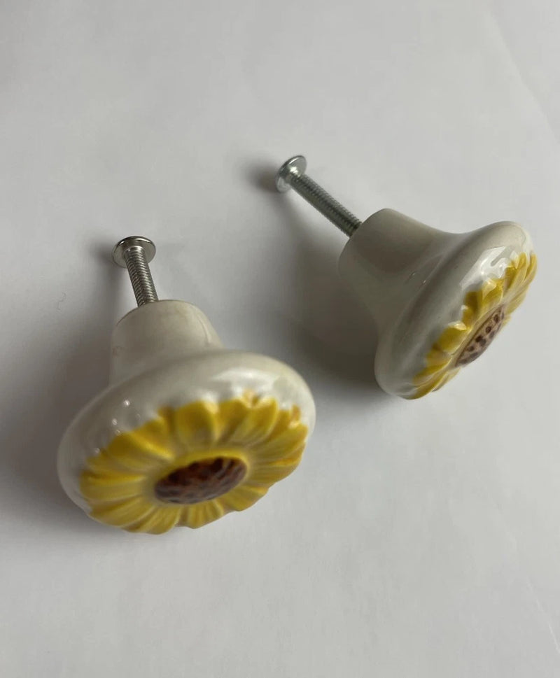Pair of ceramic drawer pulls with sunflower flower face and yellow center, rustic knob handles