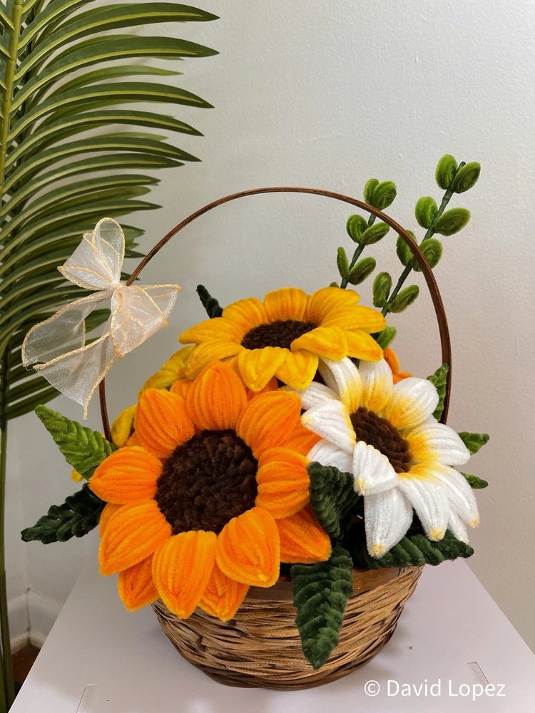 Wicker sunflower floral basket with orange and yellow blooms and white ribbon bow