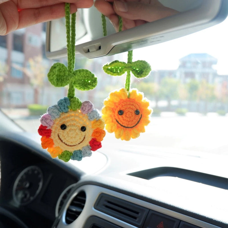 Crochet sunflower car mirror hanging with two smiling flowers and green hanging loops
