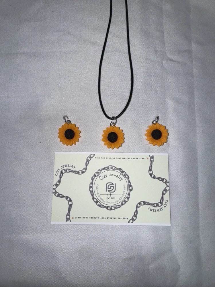 Sunflower resin pendant necklace with three dark sunflower charms on black cord