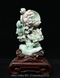 Carved jade peony flower moon sculpture with white blossoms on a turquoise base
