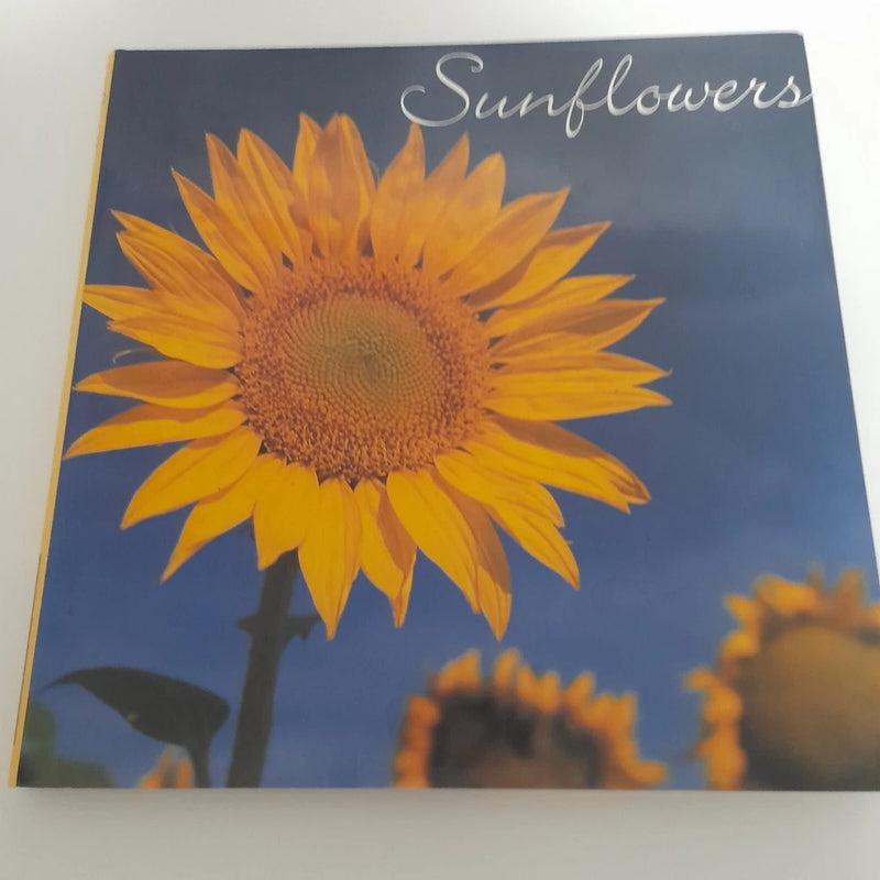 Sunflower book cover with large yellow bloom and blue background, with 'Sunflowers' text