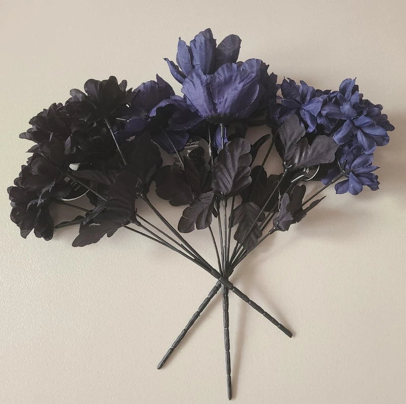 Three-piece floral bouquet with black and blue bush flowers, bundled with green stems