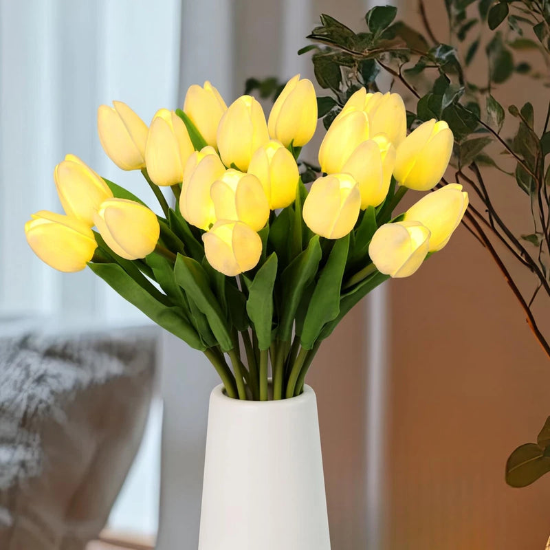 Artificial tulip bouquet, yellow blooms with green leaves in white vase