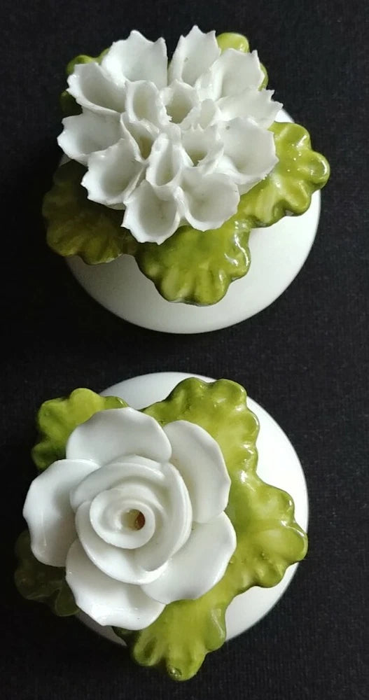 Porcelain salt and pepper shakers with white flower and green leaf design