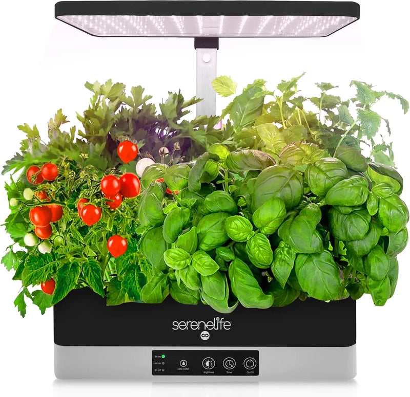 Indoor hydroponic herb garden with LED grow light panel, leafy greens and red tomatoes