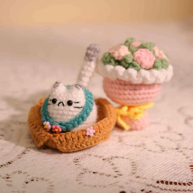 Crochet keychain with teal crocheted face detail inside an orange loop base