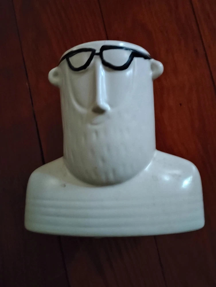 White ceramic figurine vase shaped like a torso bust with black glasses