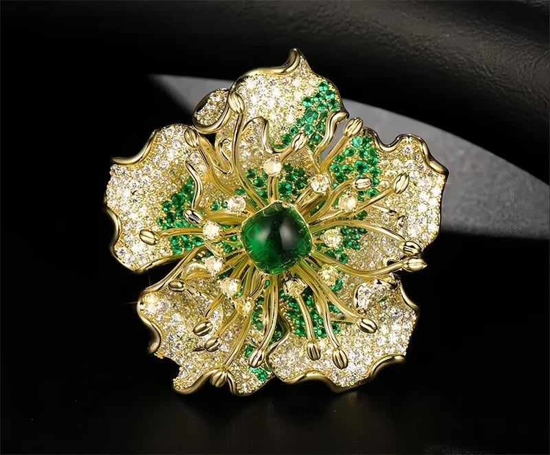 Gold-tone peony flower brooch with green enamel petals and a green center gem, rhinestone detail
