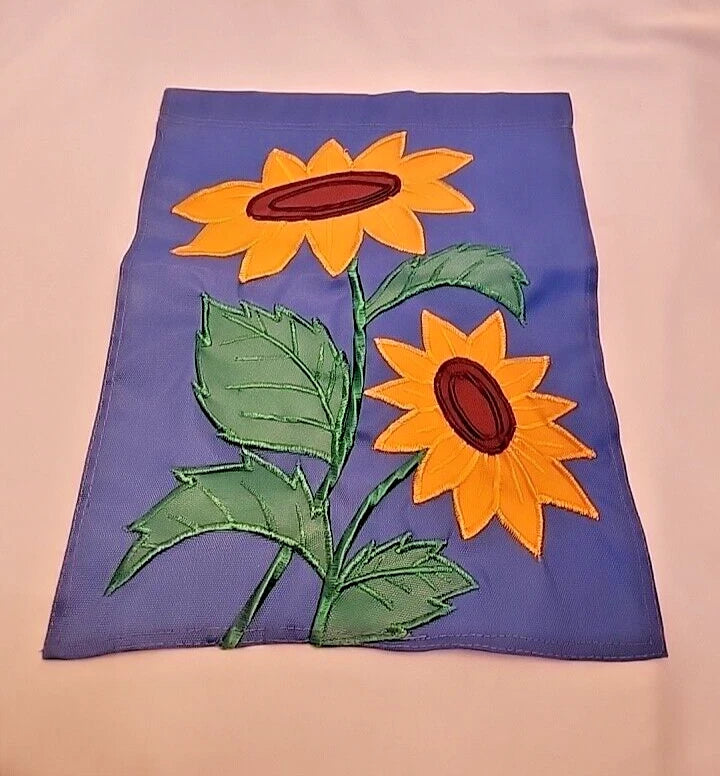 Blue embroidered garden flag with two yellow sunflowers and green leaves
