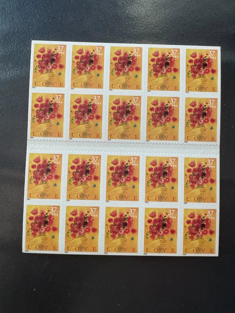 Sheet of multiple 37¢ LOVE bouquet stamps with red and pink flowers.