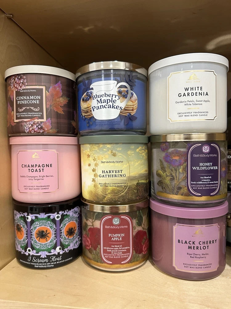 Bath & Body Works candle assortment in assorted colored tins with scent labels