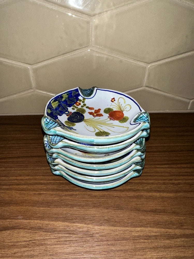 Round ceramic ashtray dish, blue rim with floral pattern, stacked with matching pieces