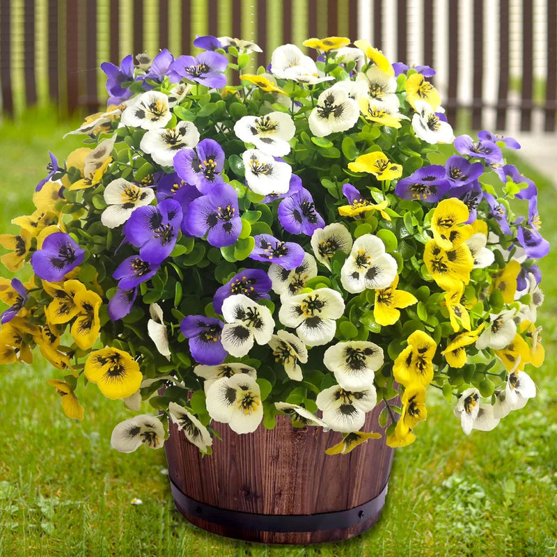Artificial spring flower arrangement in wooden planter, yellow, purple, and white blooms