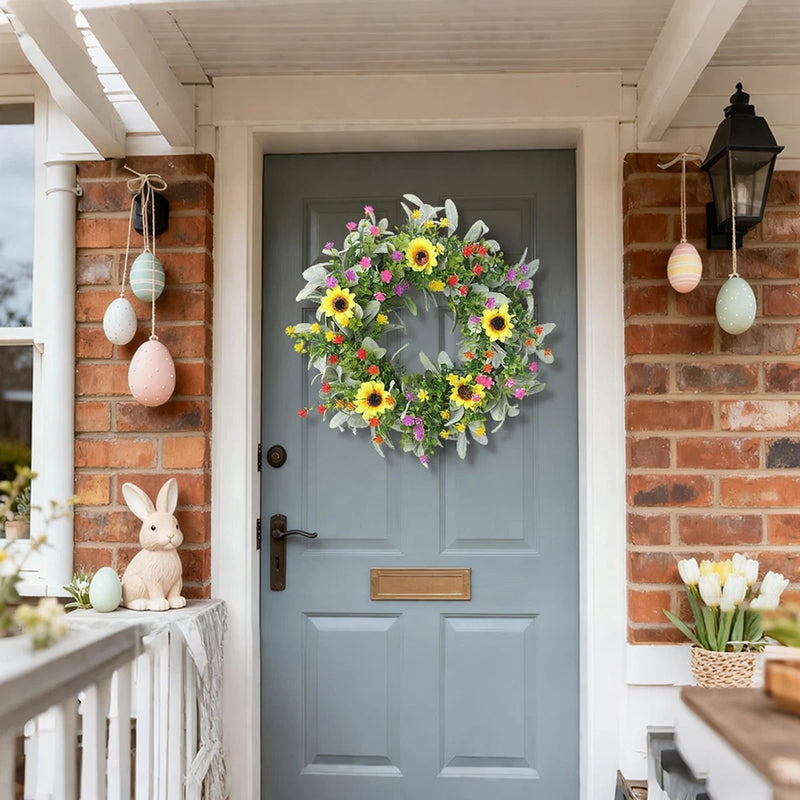 Spring sunflower wreath with circular floral design, yellow daisies, pink and white blooms.