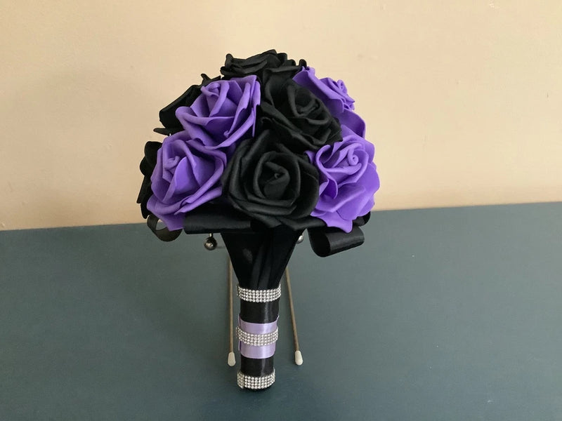 Wedding bouquet with black and lavender rose-like fabric flowers, beaded ribbon wrap