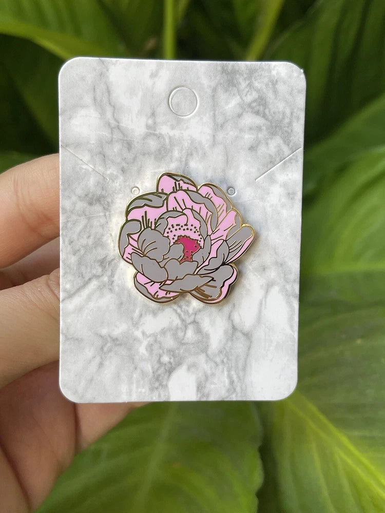 Peony flower enamel pin with pink-and-purple blossom illustration on gray marble backing card