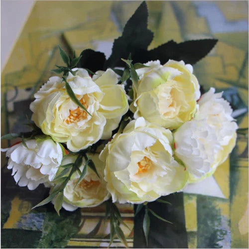 Ivory artificial silk peony flower bouquet with ruffled blooms and green leaves