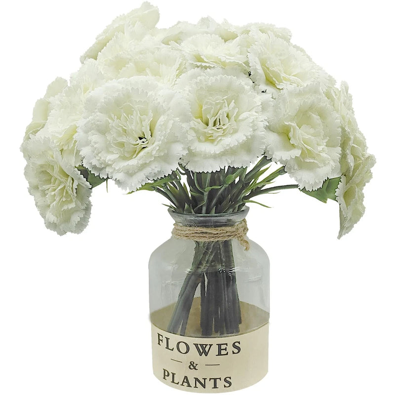 White faux silk carnation bouquet with stems in glass vase, tied with ribbon