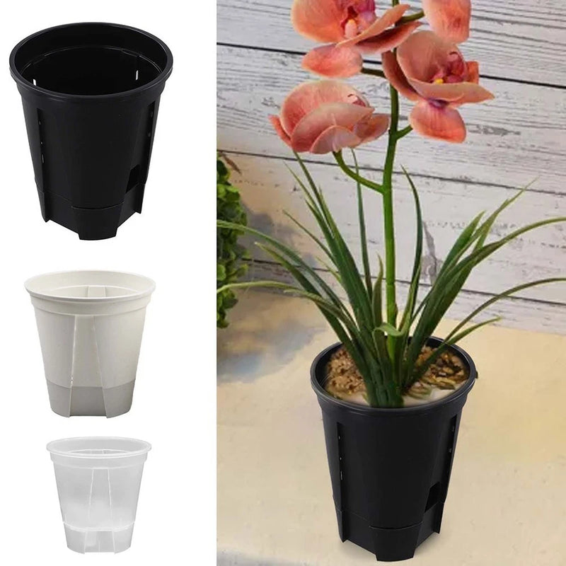 Self-watering plastic plant pots with base, black and white, shown with a potted plant
