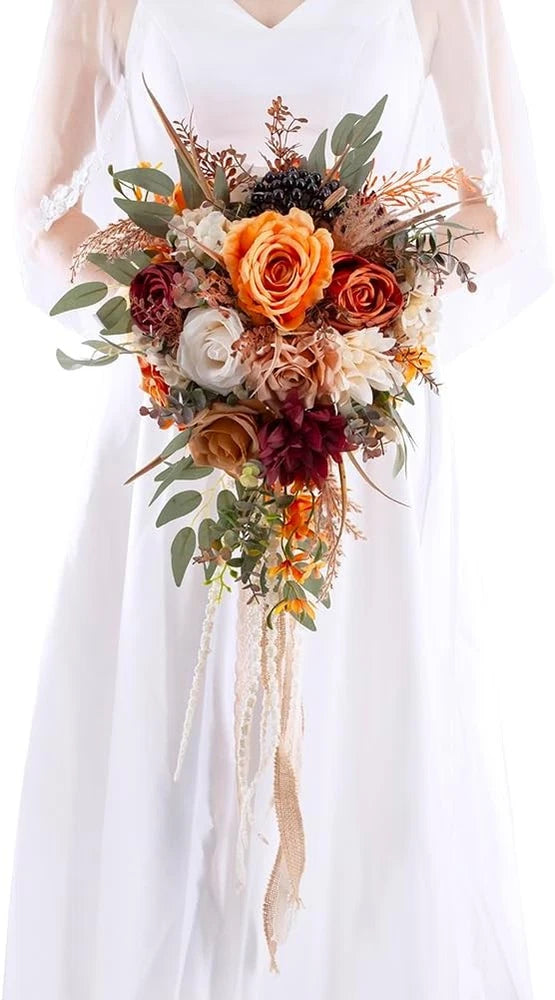 Cascading bridal bouquet with orange and burgundy roses, greenery, and long lace streamers