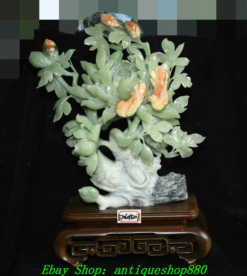 Carved green jade-style peony and bird figurine on decorative wooden base