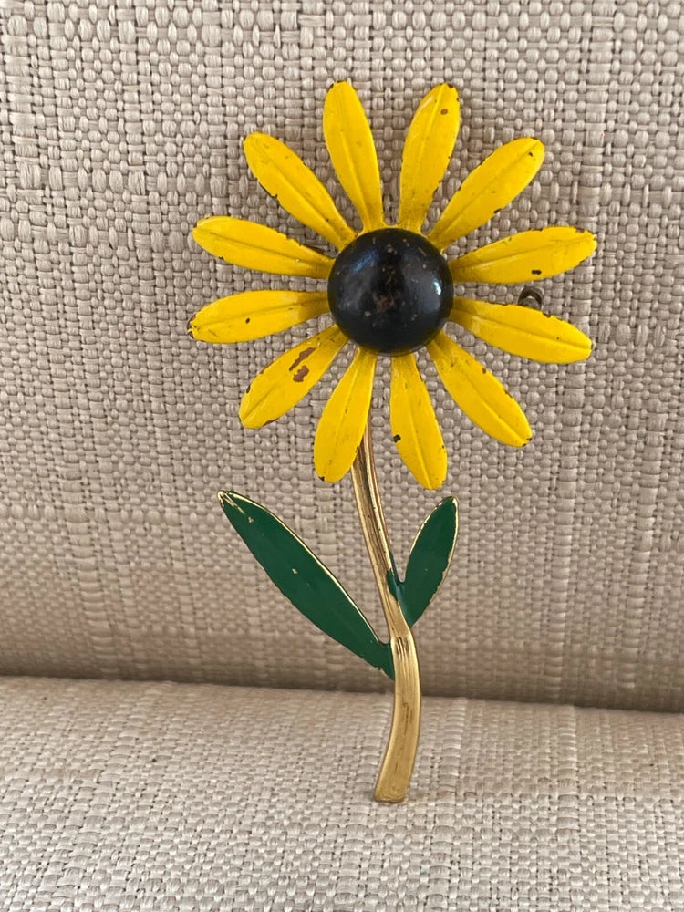 Yellow and black sunflower brooch pin with green leaves and gold-tone stem