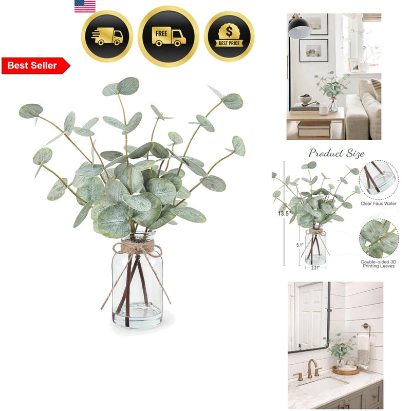 Artificial eucalyptus stems in clear glass vase with faux water and green leaves