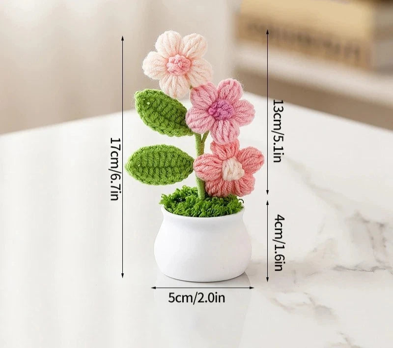 Handmade crochet potted plant decor with pink flowers, green leaves, in white pot