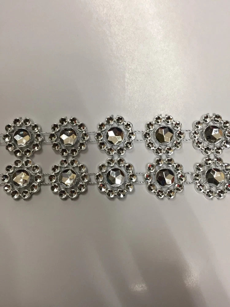 Silver sunflower-style rhinestone plastic trim with repeating flower medallions