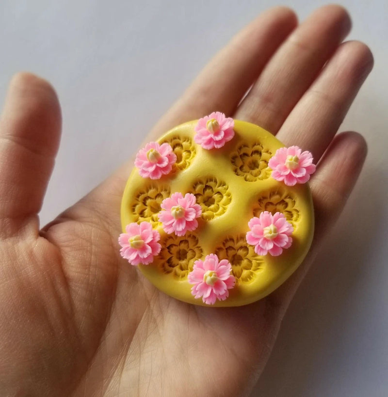 Yellow carnation flower candy mold with floral cavities and pink fondant flowers
