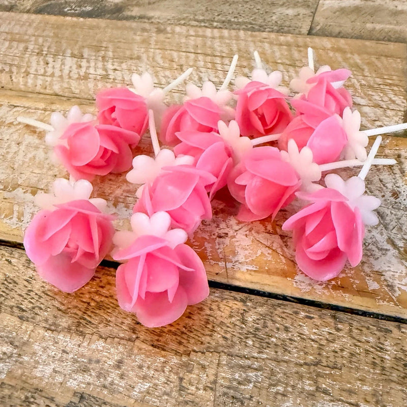 Pink plastic rose cake picks on white sticks for cupcakes