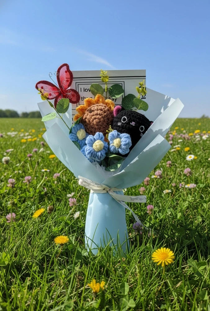 Crochet flower bouquet with black cat plush, sunflower, blue and white crochet flowers
